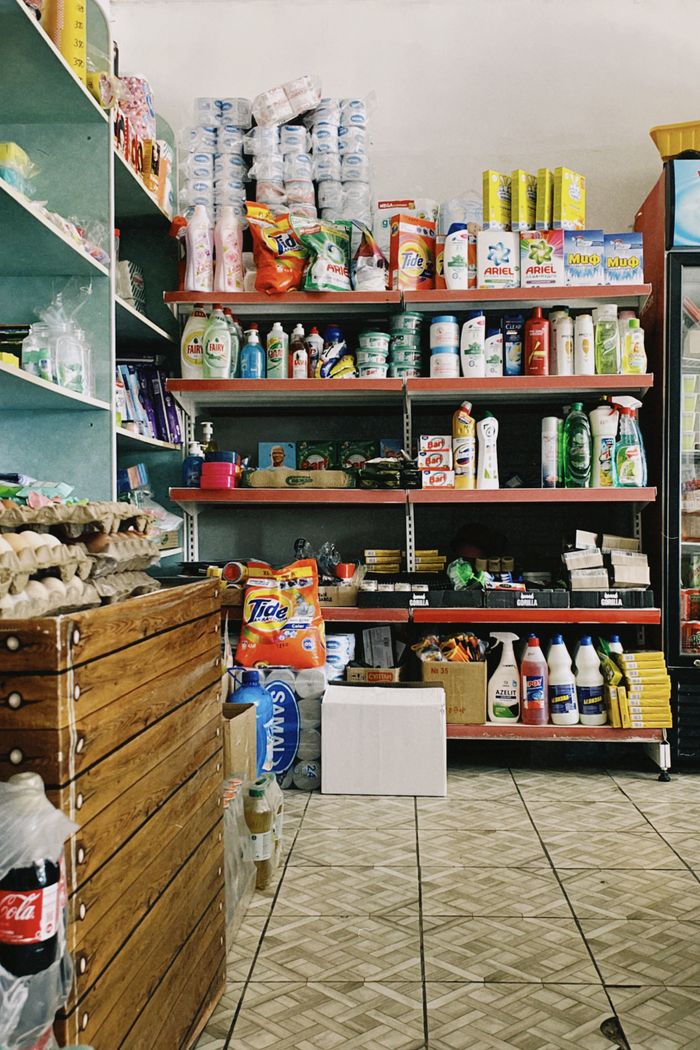 A small local shop in Shymkent, Kazakhstan with diverse merchandise displayed on shelves.